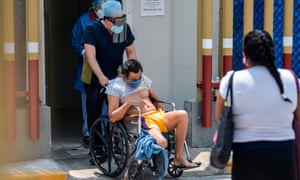 A health worker pushes Manuel Herndez, 52, on a wheelchair at the triage area of the General Hospital in Mexico City on May 9, 2020, amid the new Covid-19 coronavirus pandemic. (Photo by PEDRO PARDO / AFP) (Photo by PEDRO PARDO/AFP via Getty Images)