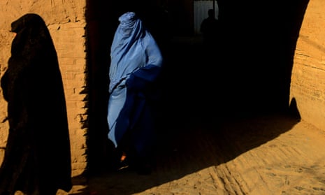 A burqa-clad woman walks in the Afghan city of Herat