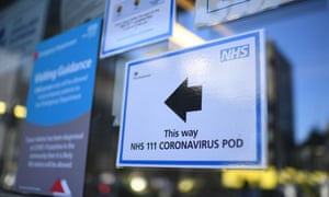 A sign points the way to a NHS 111 Coronavirus Pod at The Royal London Hospital in London