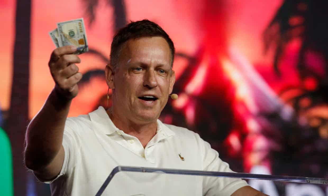 <div class=__reading__mode__extracted__imagecaption>Peter Thiel holds hundred dollar bills as he speaks during the Bitcoin 2022 Conference in Miami. Photograph: Marco Bello/Getty Images<br>Peter Thiel holds hundred dollar bills as he speaks during the Bitcoin 2022 Conference in Miami. Photograph: Marco Bello/Getty Images</div>