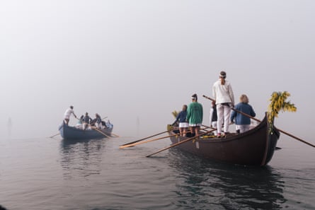 Two gondolas full of people head into the mist