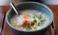 A congee with egg, sliced onions and chilli flakes