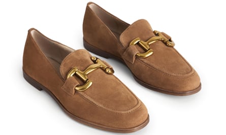 A pair of camel loafers with a large gold chain detail on the top
