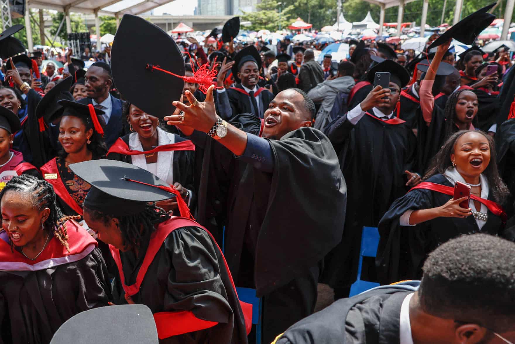 A large group of people in graduate gowns and hats
