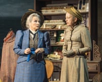 Jennifer Saunders and Lucy Briers in period costume talking in a cluttered fabric shop scene