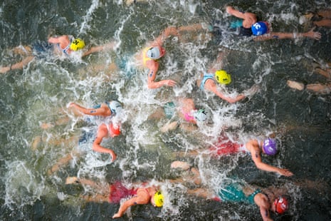 Australia’s Natalie Van Coevorden, centre, fights among a crowded field as she competes in the swim leg of the women’s individual triathlon competition.