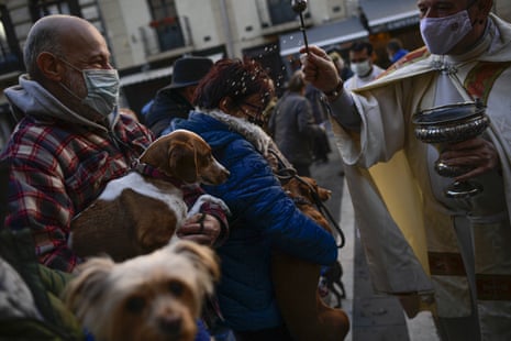 Priest Cesar Magana blesses animals and their owners during the feast of St Anthony, Spain’s patron saint of animals, in Pamplona, northern Spain, during the Covid pandemic.