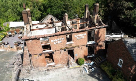The burnt-out remains of the 18th century Crooked House pub near Dudley seen before it collapsed on Monday.