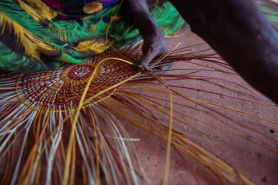 'Bringing the sun in': Bula'Bula's hardworking weavers dig color out of the red soil | native art Evonne weaves a traditional mat at Bula'Bula
