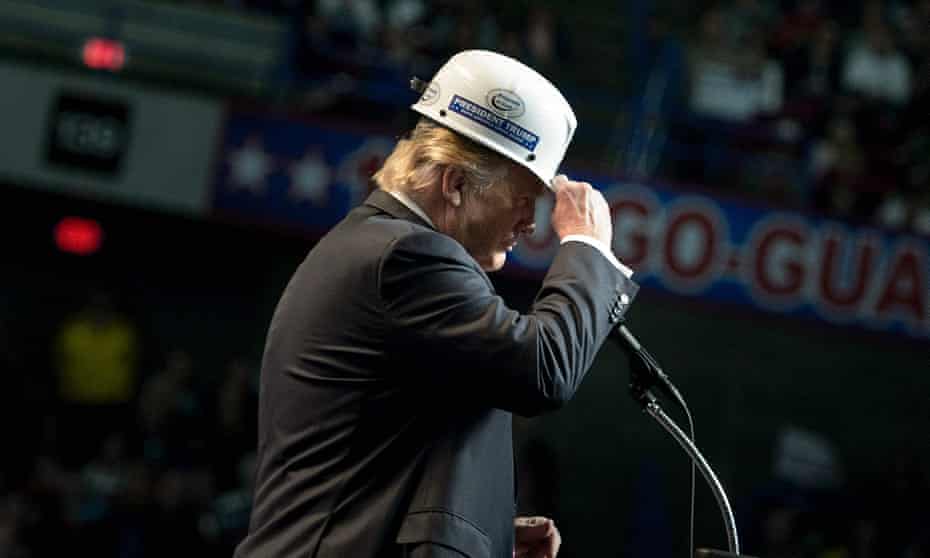 Donald Trump puts on a miner’s hat while speaking during a rally in Charleston, West Virginia.