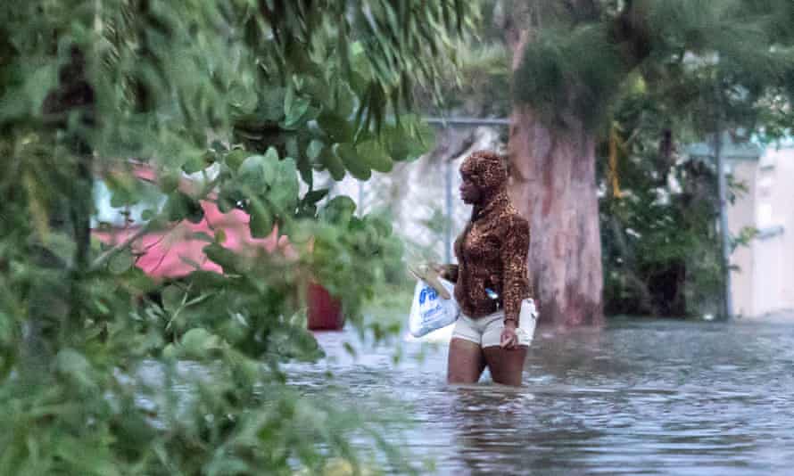A woman walks in a flooded street after the effects of Hurricane Dorian arrived in Nassau, Bahamas.
