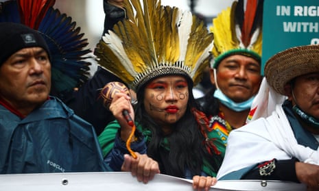 Members of the Amazonian Minga people protest at COP26.