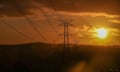 Sun sets behind transmission wires and towers