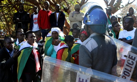 Riot police and anti-government activists in Harare as tensions in the country remain high.
