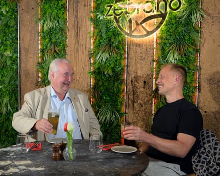 Robin and Aslak laughing at a restaurant table