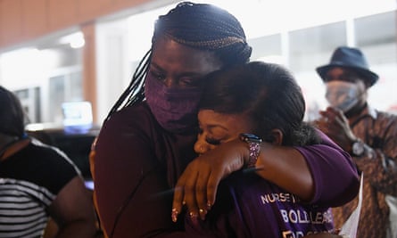 Cori Bush, left, hugs her daughter prior to giving her victory speech in St Louis, Missouri, on 4 August.