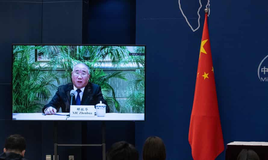 A screen showing Xie Zhenhua, China's special envoy for climate change, speaking during a media briefing.