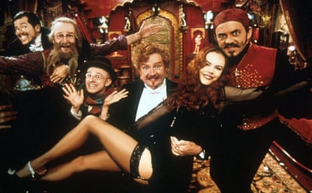 A group of men carrying a woman wearing black and stockings