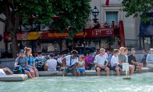 People sitting in the fountains in Trafalgar Square on Monday.