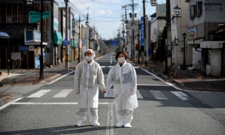 Couple hold hands on Fukushima street
