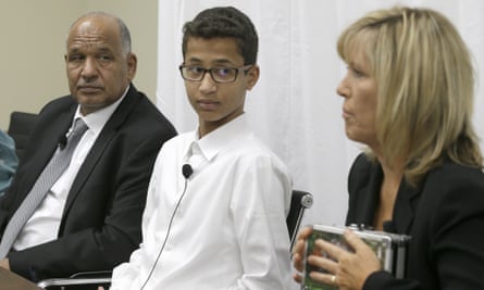 Ahmed Mohamed and his father, Mohamed Elhassan Mohamed, look on as their lawyer Susan E Hutchison speaks in Dallas.
