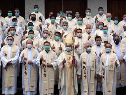 Taiwanese Archbishop John Hung Shan-chuan and priests after celebrating the Chrism Mass behind closed doors at the Holy Family Church in Taipei.