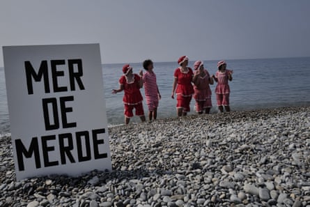 Retro-styled performers known as the Bathing Beauties stage a beachside tableau titled ‘Mer de Merde’ (‘Sea of shit’) on a beach