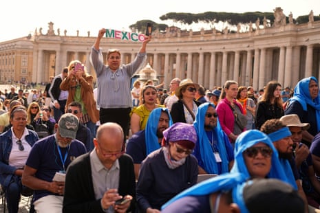 People watch as the coffin with the body of Pope Francis, who will lie in state at St. Peter's Basilica for three days, is carried in St. Peter's Square, at the Vatican.