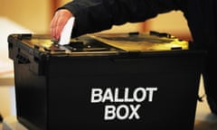 a voter placing a ballot paper in the ballot box