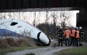 Emergency personnel work at an accident scene where a high-speed TGV train derailed during a test
