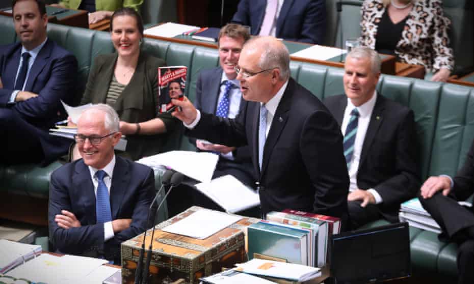 Scott Morrison holding up a book in parliament