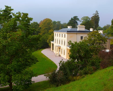 A large Georgian house set among trees