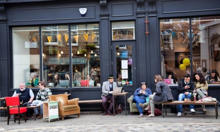 People relax outside the Covent Garden branch of Timberyard, a hybrid coffee shop and workspace.