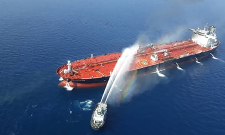 An Iranian navy boat tries to control fire aboard the Norwegian-owned Front Altair tanker, reportedly attacked in the Gulf of Oman.