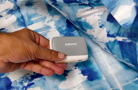 A Jabees Peace Pillow Speaker being placed underneath a pillow