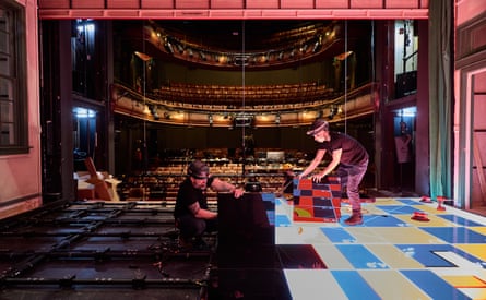 Laying digital LED panels that make up the set floor.