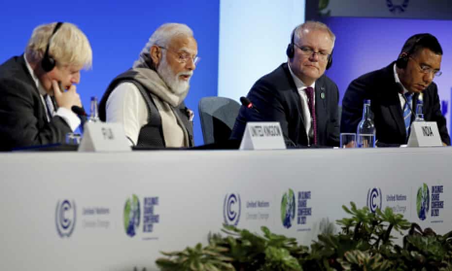 Britain's Prime Minister Boris Johnson, left, India's Prime Minister Narendra Modi, second left, Australia's Prime Minister Scott Morrison and Jamaica's Prime Minister Andrew Holness, right, attend a meeting during the UN Climate Change Conference COP26 in Glasgow.