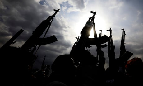 Houthi supporters hold up weapons during a protest in Yemen