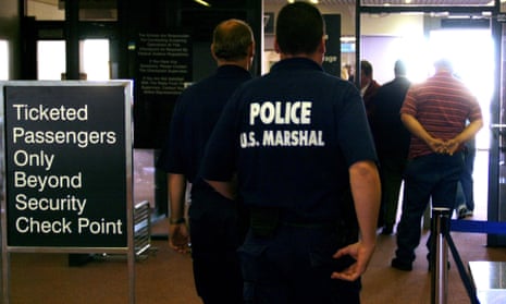 US Marshals patrol a security checkpoint at Logan Airport in Boston. The Marshals service is part of the justice department.