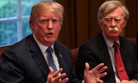 Donald Trump, left, flanked by national security advisor John Bolton, right, speaks at the White House in April 2018.