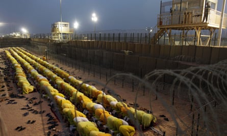 Detainees pray at Camp Bucca, the former US military prison in Iraq, in 2009.
