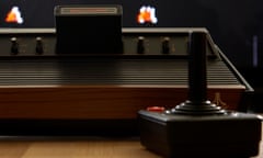 retro electronic video game original atari vcs 2600 six switch woodie and joystick playing space invaders video game. Image shot 2016. Exact date unknown.<br>BPH6FT retro electronic video game original atari vcs 2600 six switch woodie and joystick playing space invaders video game. Image shot 2016. Exact date unknown.