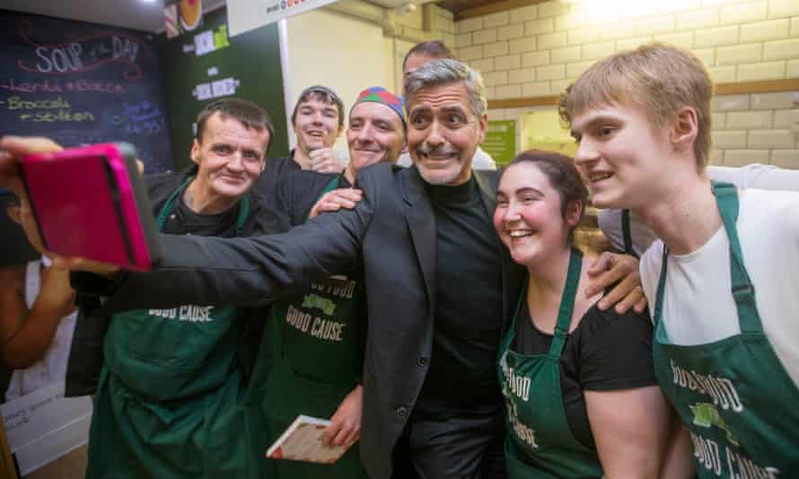 George Clooney takes a selfie with staff as he visits Social Bite, Edinburgh, in November 2015.