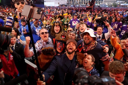 Caleb Williams celebrates with fans after being selected first overall by the Chicago Bears during the first round of the 2024 NFL draft at Campus Martius Park and Hart Plaza.