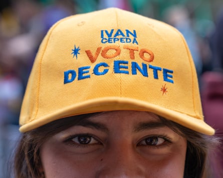 A closeup of a woman in a baseball cap bearing the words ‘Iván Cepeda, a decent vote’