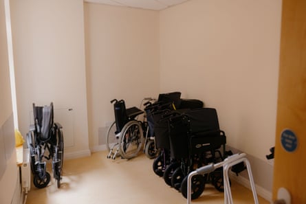 A storage cupboard full of wheelchairs