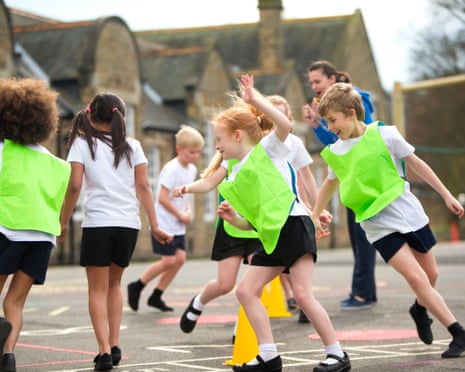 Children during a PE lesson in a playground.