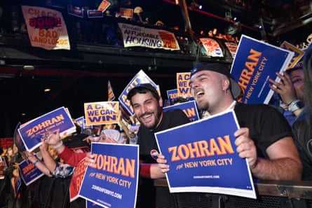 people holding signs and cheering