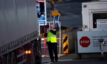 A UK border agent checks a lorry at a customs point