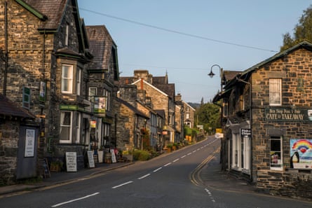 Stone cottages and village shops of Betws-y-Coed line a main street.